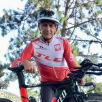 A participant poses with his bicycle at the Dr. Craig Schultz Memorial 20k-40k Time Trial in Cordova, IL
